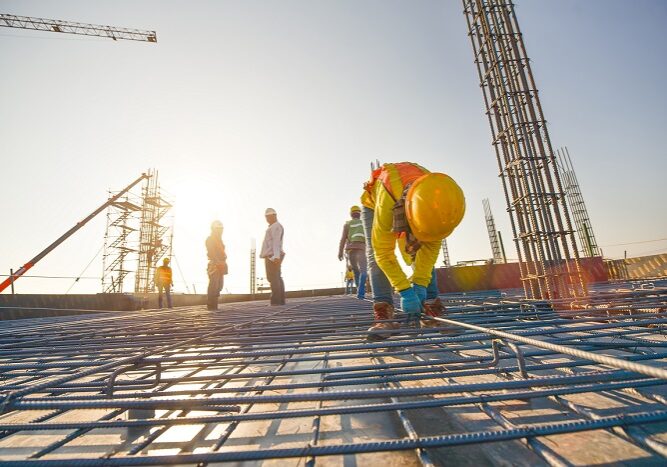 Construction workers fabricating steel reinforcement bar at the construction site